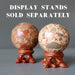 two safari jasper spheres on fancy wood display stands which are sold separately
