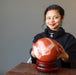 woman with red jasper ball