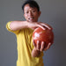 man holding red jasper ball