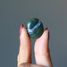 hand holding a Green Jasper Tumbled Stone