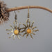yellow jasper sun earrings hanging on a branch