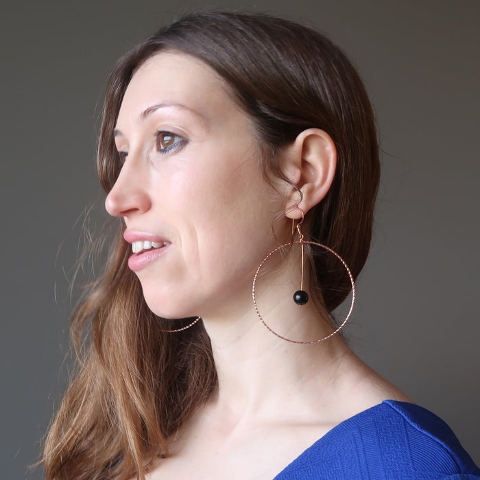 holly from satin crystals wearing jet stones in big copper hoop earrings