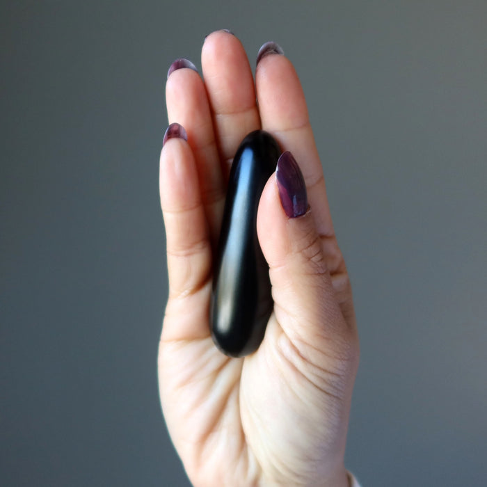 hand holding a jet stone massage wand