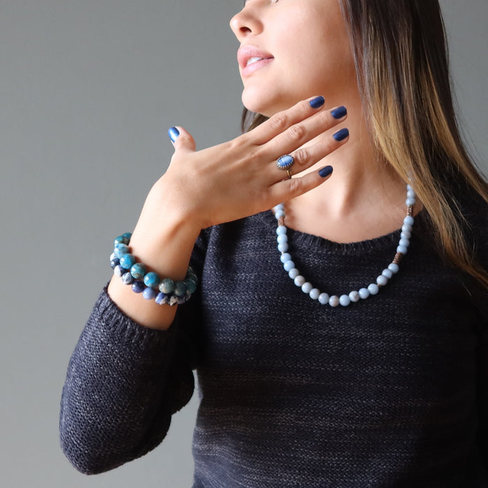 woman wearing blue kyanite oval in adjustable brass ring