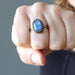 woman wearing blue kyanite oval in adjustable brass ring