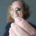 woman holding blue kyanite oval in adjustable brass ring