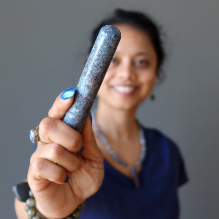 sheila of satin crystals holding up a blue kyanite massage wand