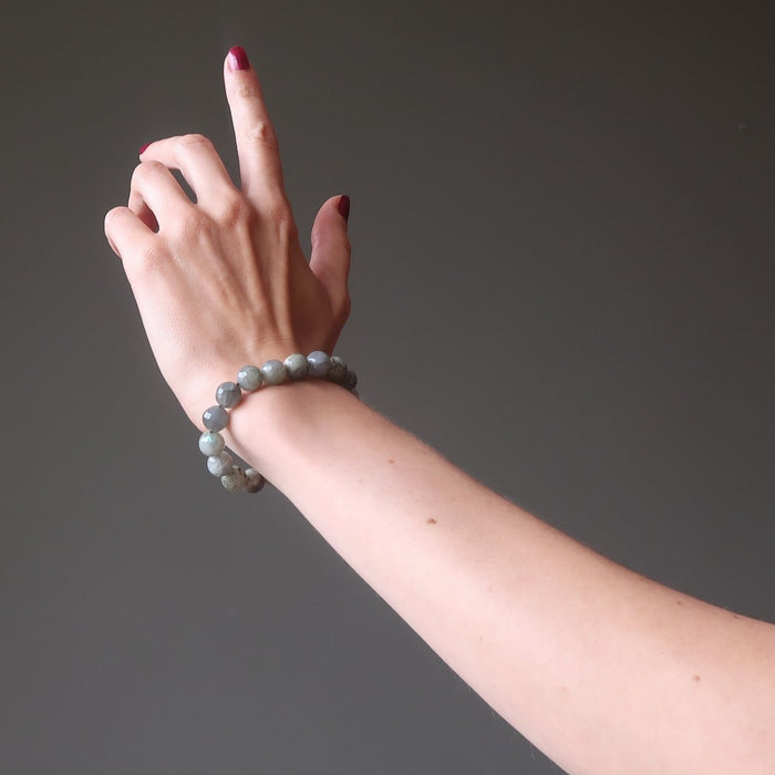 hand wearing faceted labradorite beaded stretch bracelet