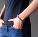 hands in jeans pocket wearing faceted labradorite beaded stretch bracelet