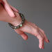 woman's hand wearing round labradorite beaded stretch bracelet
