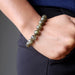 hand in pants pocket wearing round labradorite beaded stretch bracelet