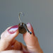 hand holding labradorite leverback earring showing open lever back