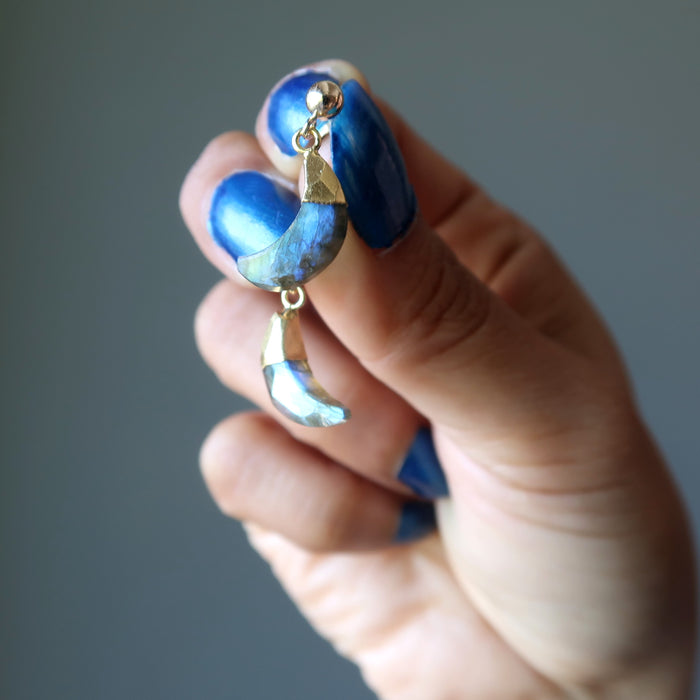 hand holding labradorite moon gold post earrings