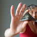 woman holding labradorite pyramid