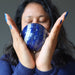 sheila of satin crystals meditating with a lapis lazuli sphere
