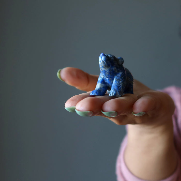 lapis bear figurine on hand