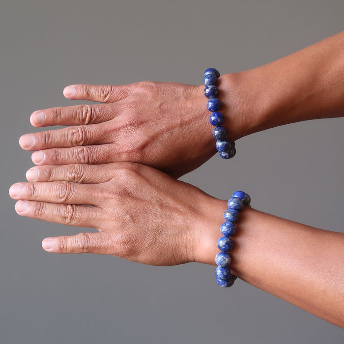 man's hands wearing lapis lazuli stretch bracelets on each wrist