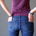 woman with hands in back jeans pocket both wearing lapis lazuli stretch bracelet