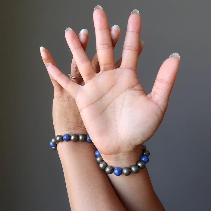 hair of hands both wearing lapis lazuli and pyrite round beaded stretch bracelet