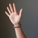 hand wearing lapis lazuli and pyrite round beaded stretch bracelet