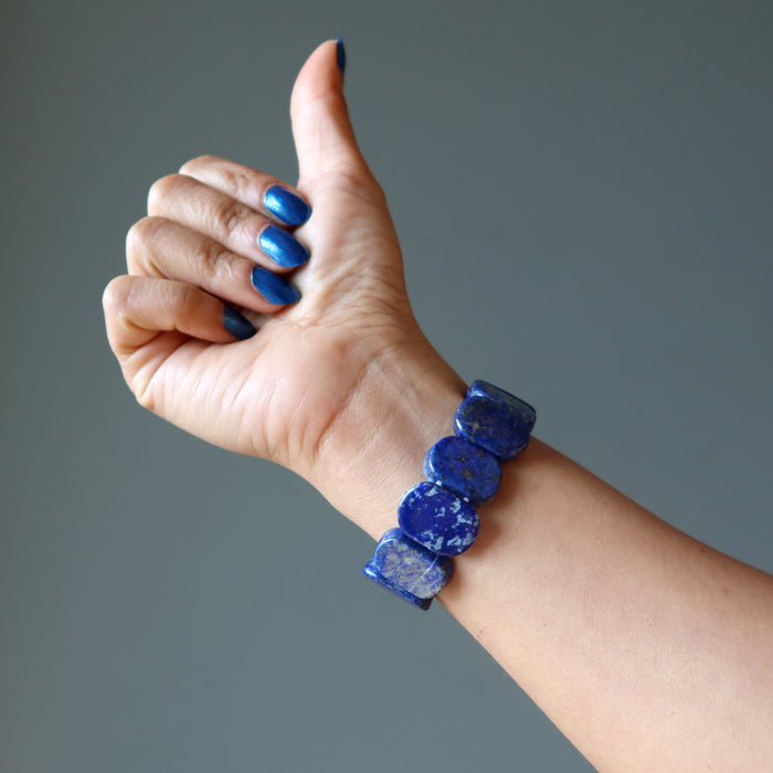 hand giving a thumbs up wearing rounded rectangle lapis beaded stretch bracelet