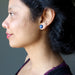 woman wearing lapis stud earring