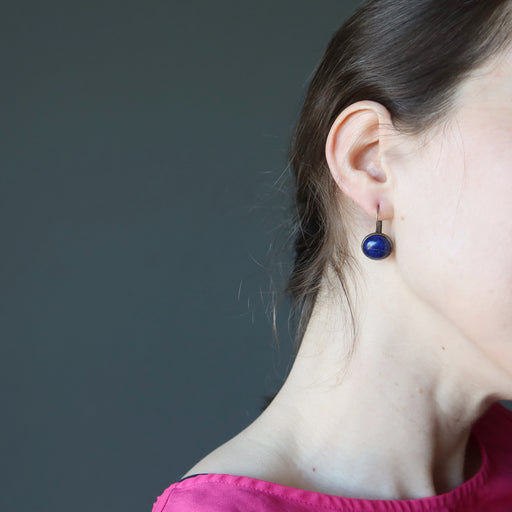 wearing round lapis lazuli in antique bronze leverback earrings