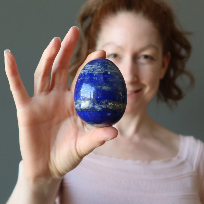 female model holding lapis egg