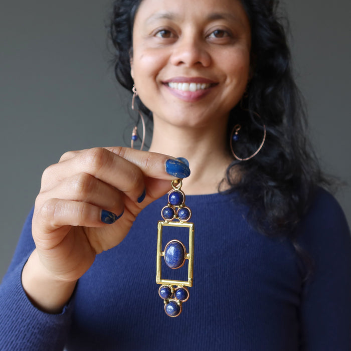 woman holding lapis designer pendant