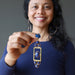 woman holding lapis designer pendant