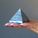 hand holding lapis pyramid