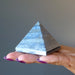 hand holding  lapis pyramid