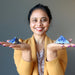 woman holding lapis pyramids in each palm of hand