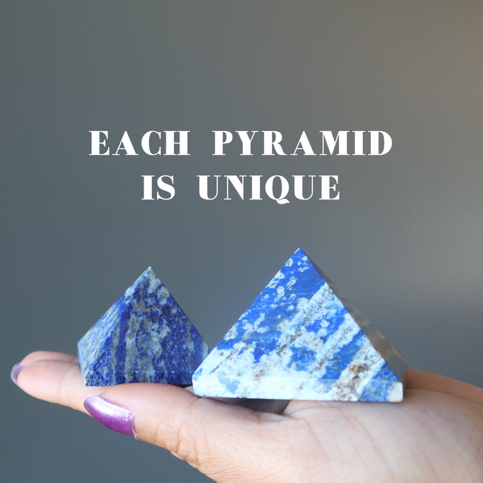 hand holding two lapis lazuli pyramids