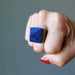 fist wearing lapis pyramid ring