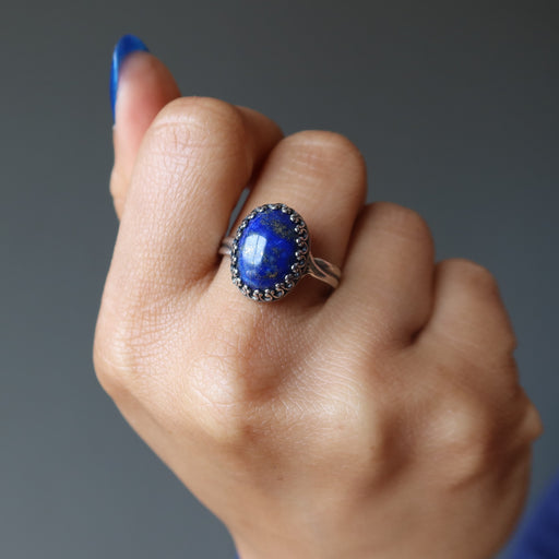loose handed fist wearing lapis lazuli sterling silver ring adjustable jewelry