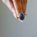 hand holding lapis lazuli sterling silver ring adjustable jewelry
