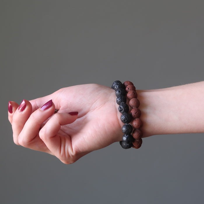 woman's hand modeling red and black lava bracelet set