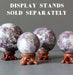 lepidolite balls on wood stands which are sold separately