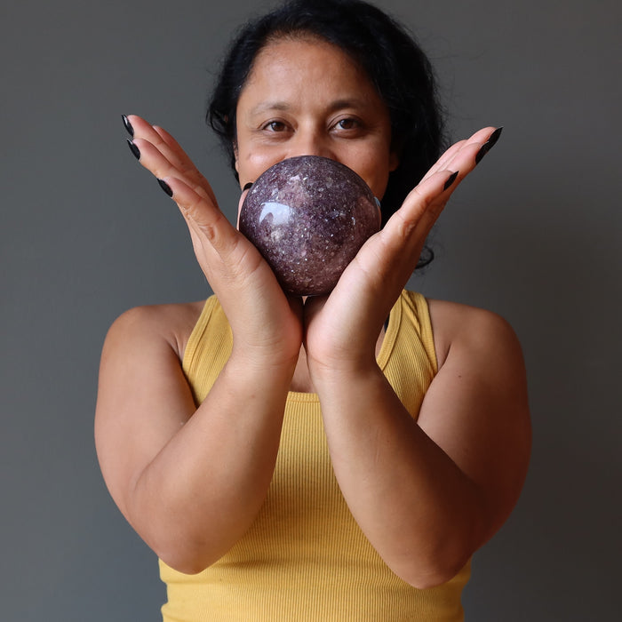 sheila of satin crystals holding a purple lepidolite sphere
