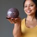 sheila of satin crystals gazing at a purple lepidolite crystal ball