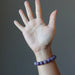 hand wearing purple lepidolite bracelet