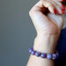 hand wearing purple lepidolite bracelet