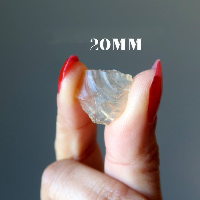 hand holding up a 20mm libyan desert glass raw tektite