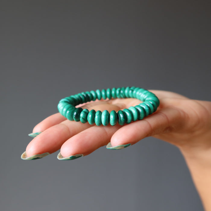malachite saucer beaded stretch bracelet on palm of hand