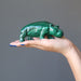 hand holding a malachite hippo figurine