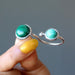 hand holding malachite double knuckle duster ring