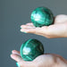 malachite sphere in hands