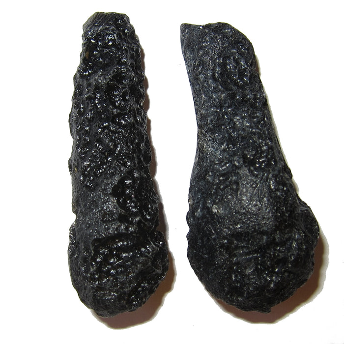 Set of two black tektite wand like meteorites that came from outer space to China. They are glassy and porous.