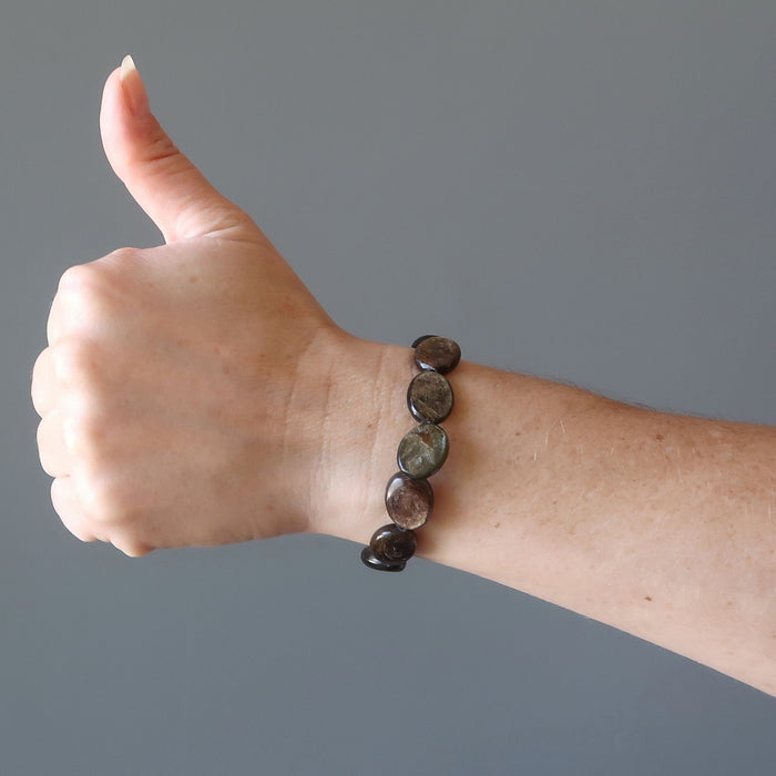 female hand with thumbs up wearing mica oval bracelet